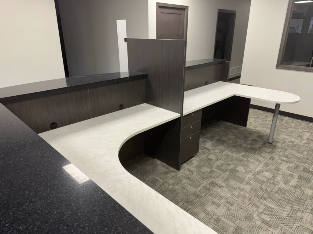 Modular banker workstation with curved return, privacy panel, and moveable drawer pedestal