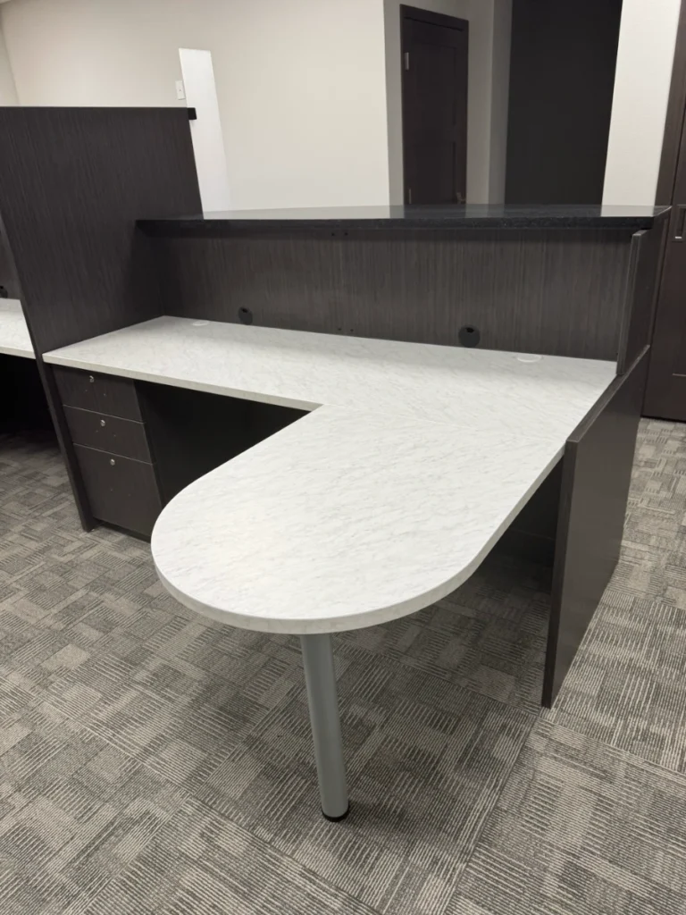 Custom executive workstation with teardrop worktop, cable grommets, and moveable pedestal